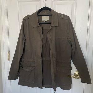 Medium green army like jacket with sinched waste.